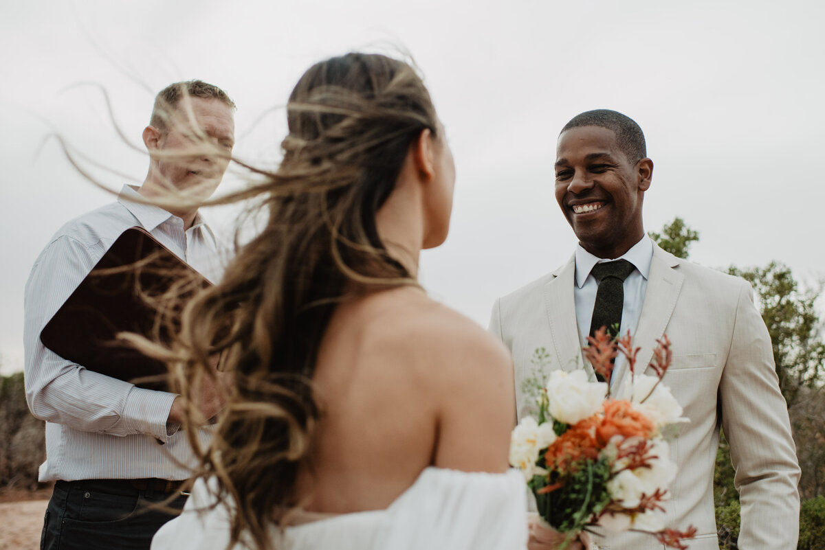 Utah Elopement Photographer captures groom smiling at bride