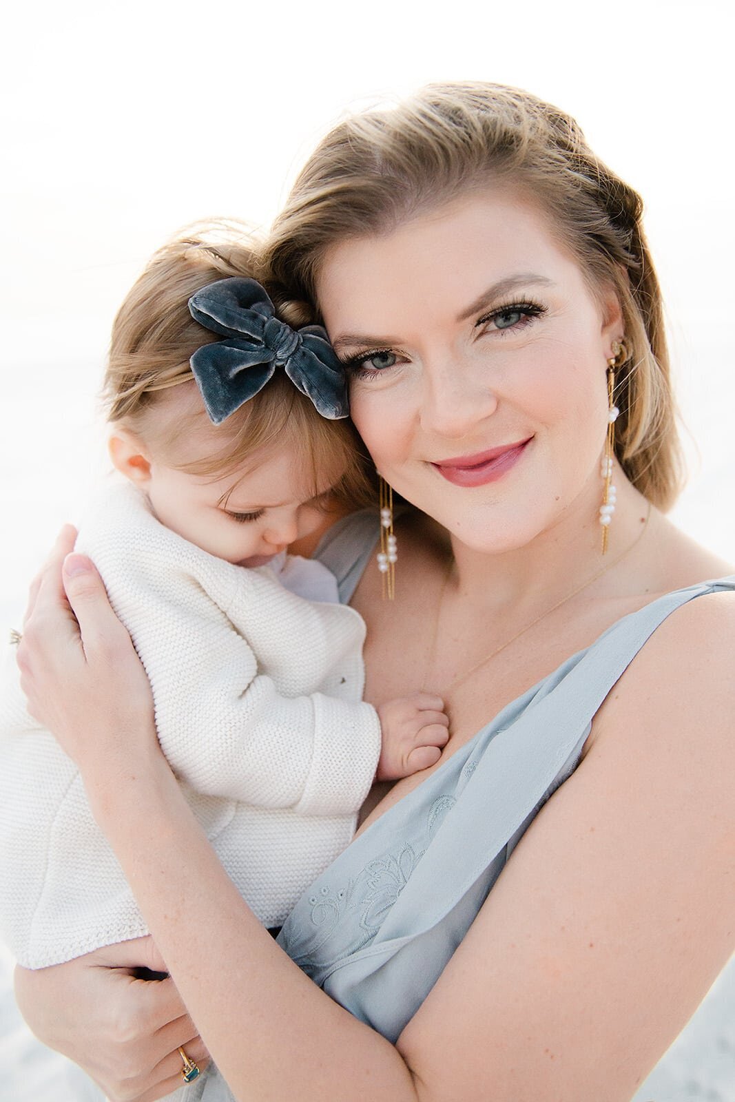 a mother smiling into destin family  photographers camera