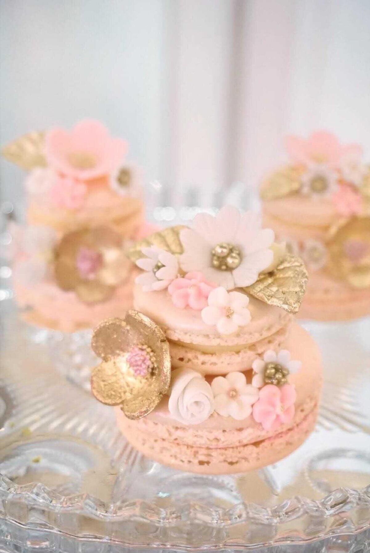 Beautiful pink macaroon cake with gold sugar flowers