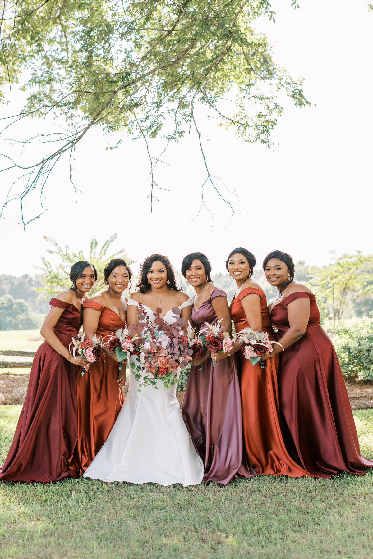 A bride stands with the bridesmaids at Green Gates Farmhouse.