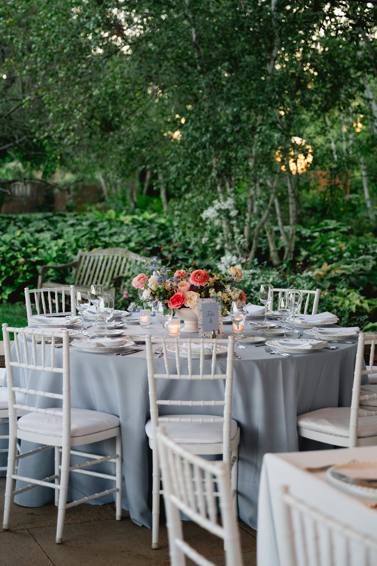 Outdoor reception setup with elegantly arranged tables under garden lights at the Chicago Botanic Gardens