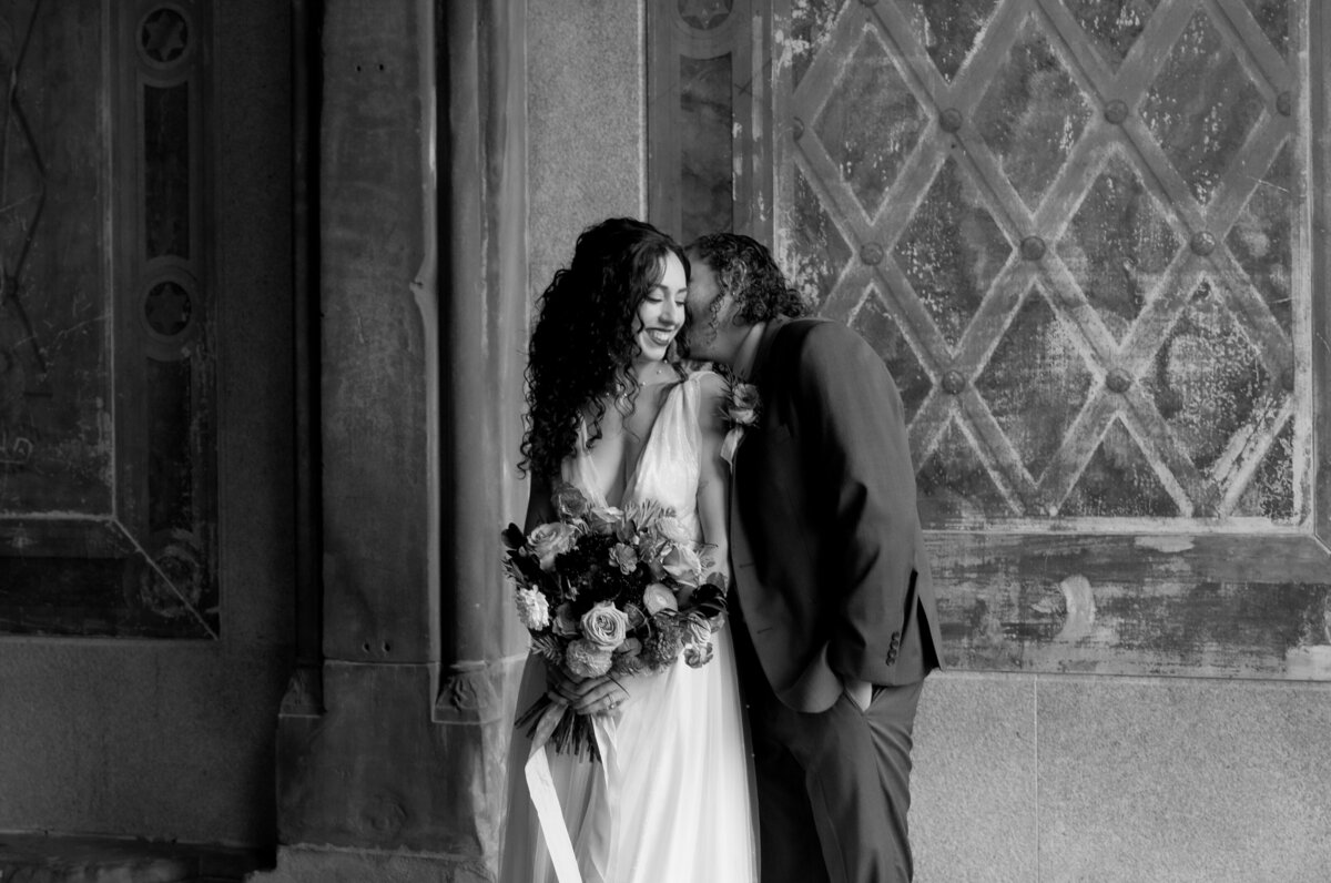 The couple sharing a tender moment beneath Central Park’s beautiful stone arches.