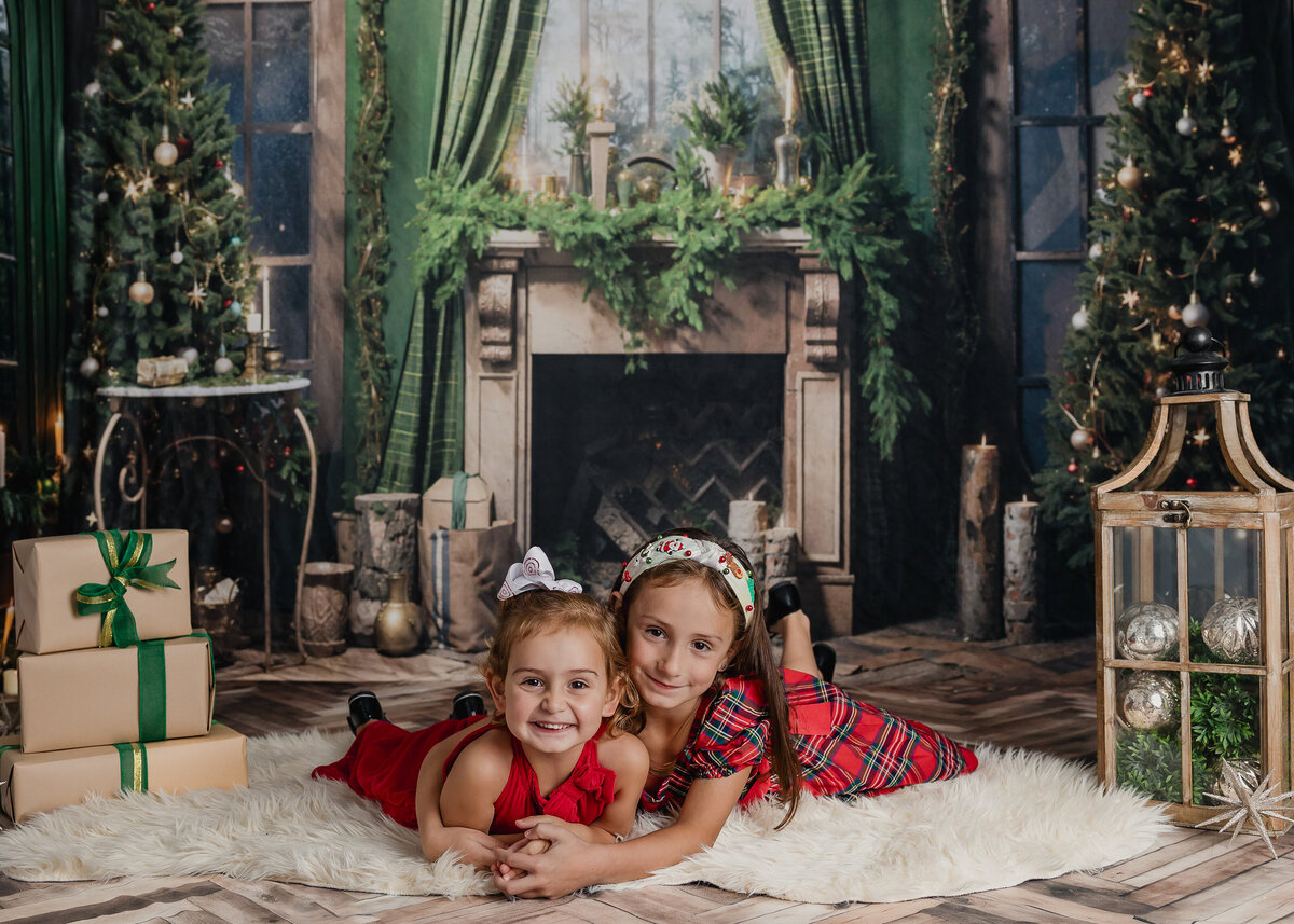 Holiday portrait of hugging siblings at Allison Reilly's Union County, NJ photo studio.