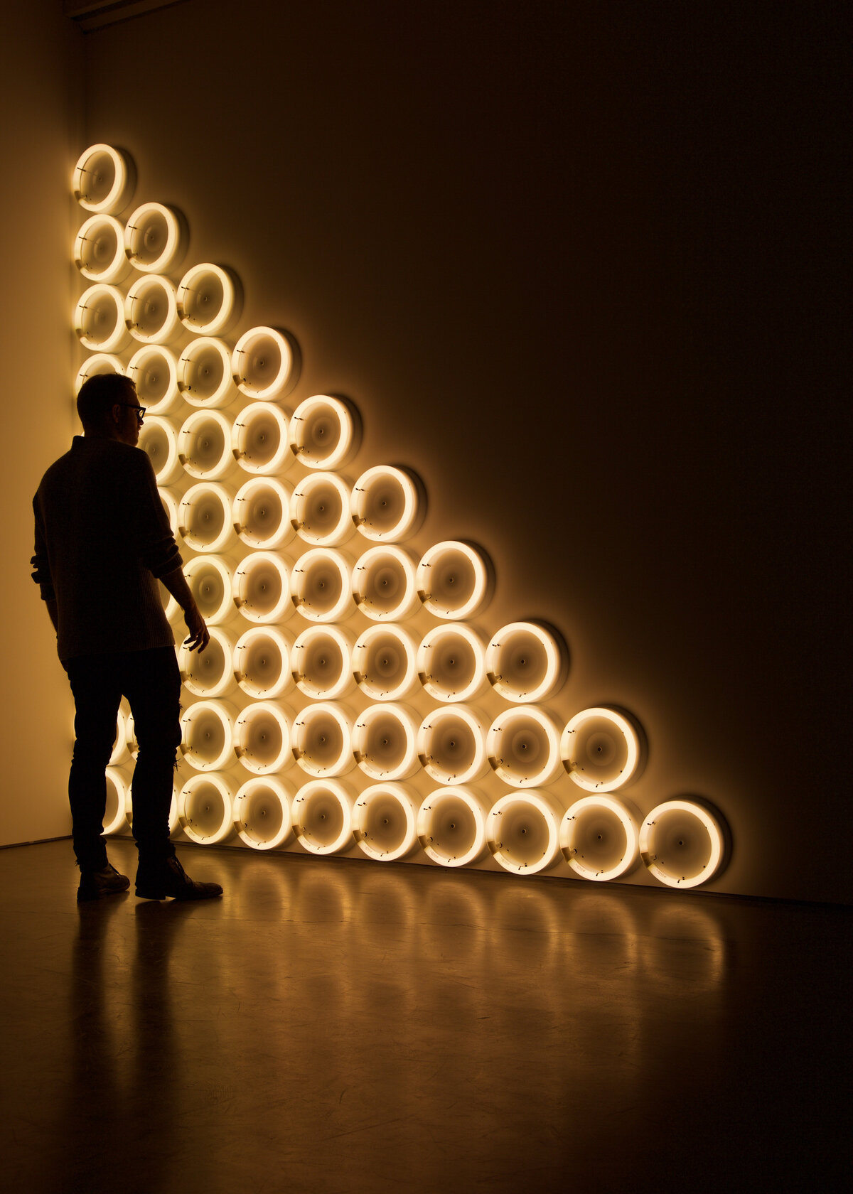 A silhouette of a man against a light installation for a luxury event brand party.