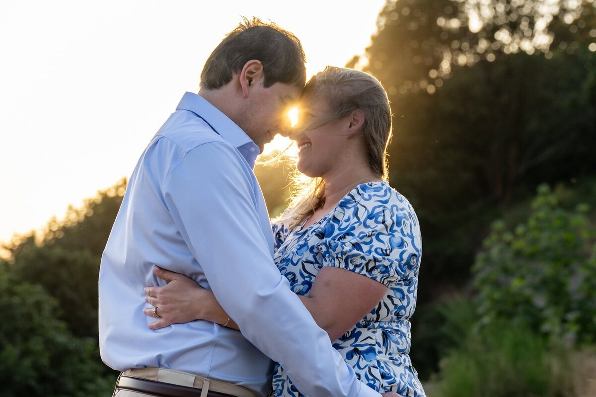 sunset at discovery park couple hug on bluff