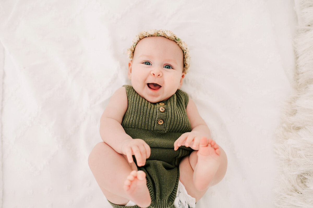 baby photo in Branson MO of smiling baby girl  during milestone session