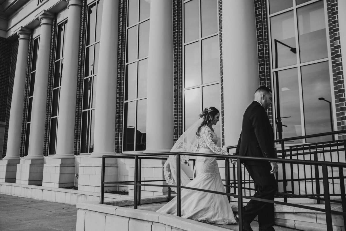 Courthouse elopement in Elyria, couple walks away from building.