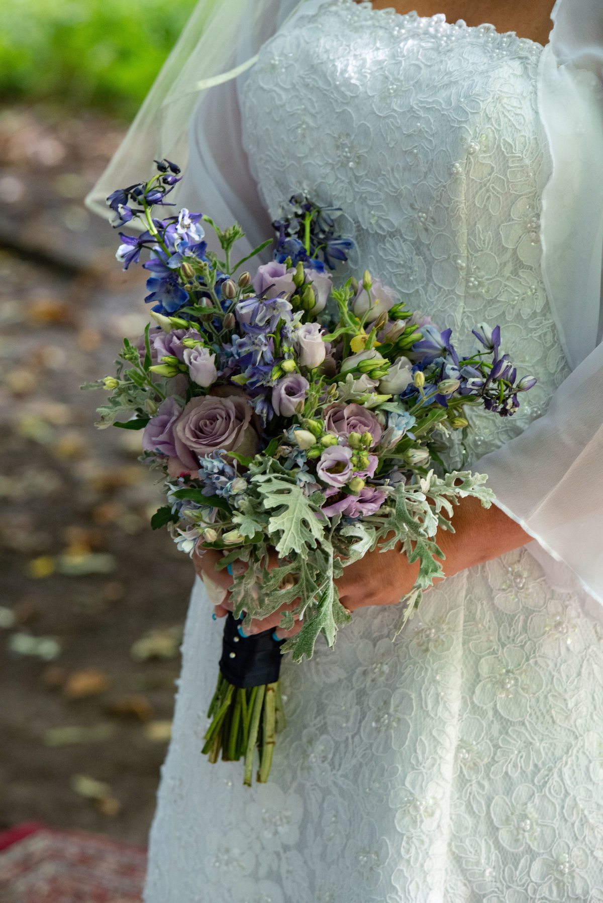 bride holding bouquet in front of dress