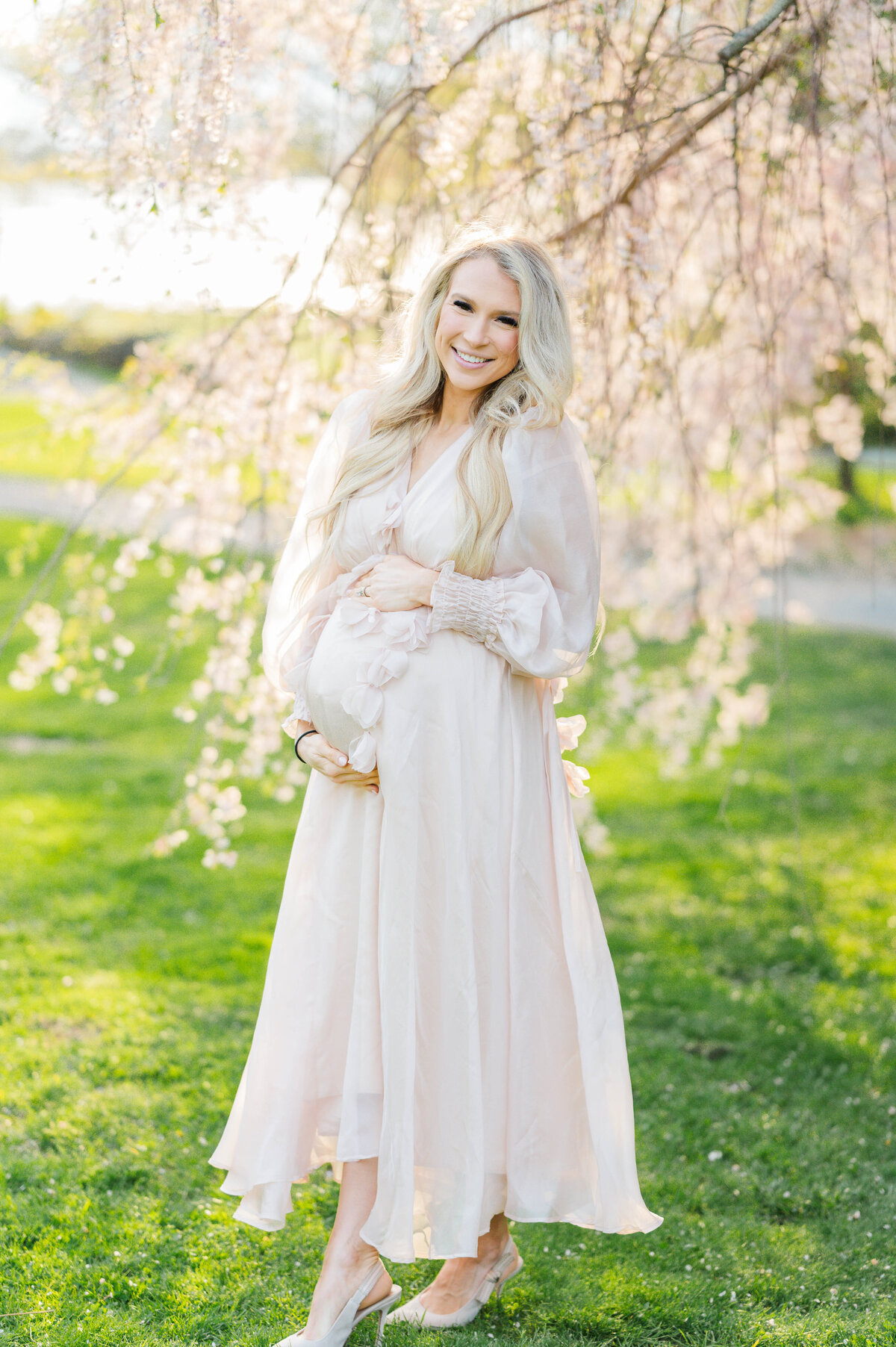 Pregnant woman holding belly in Bristol, RI at Blithewold Mansion taken by best Maternity photographer in Rhode Island