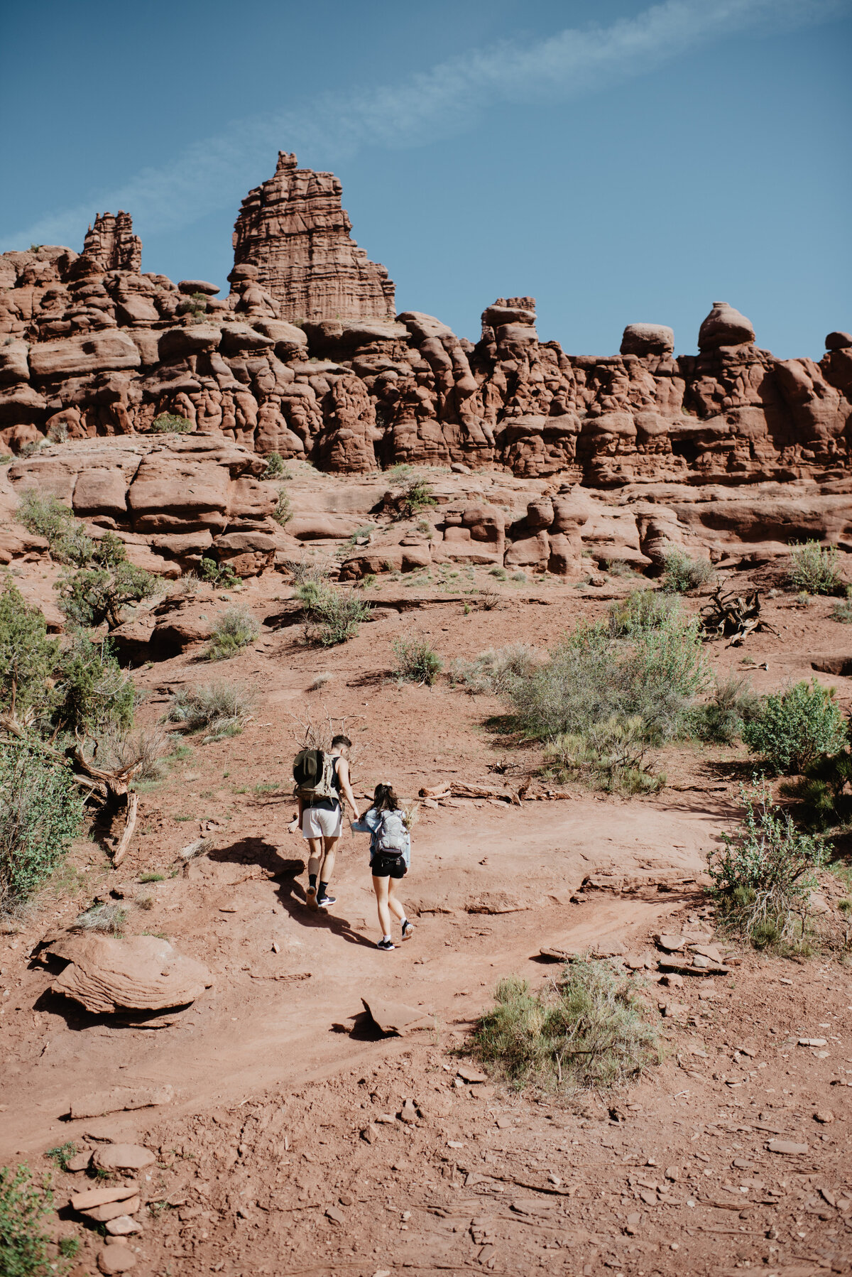 Utah Elopement Photographer captures couple walking through Moab
