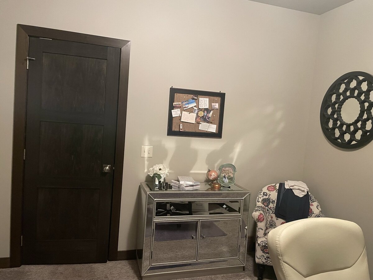 A small grey storage cabinet sits in a grey office