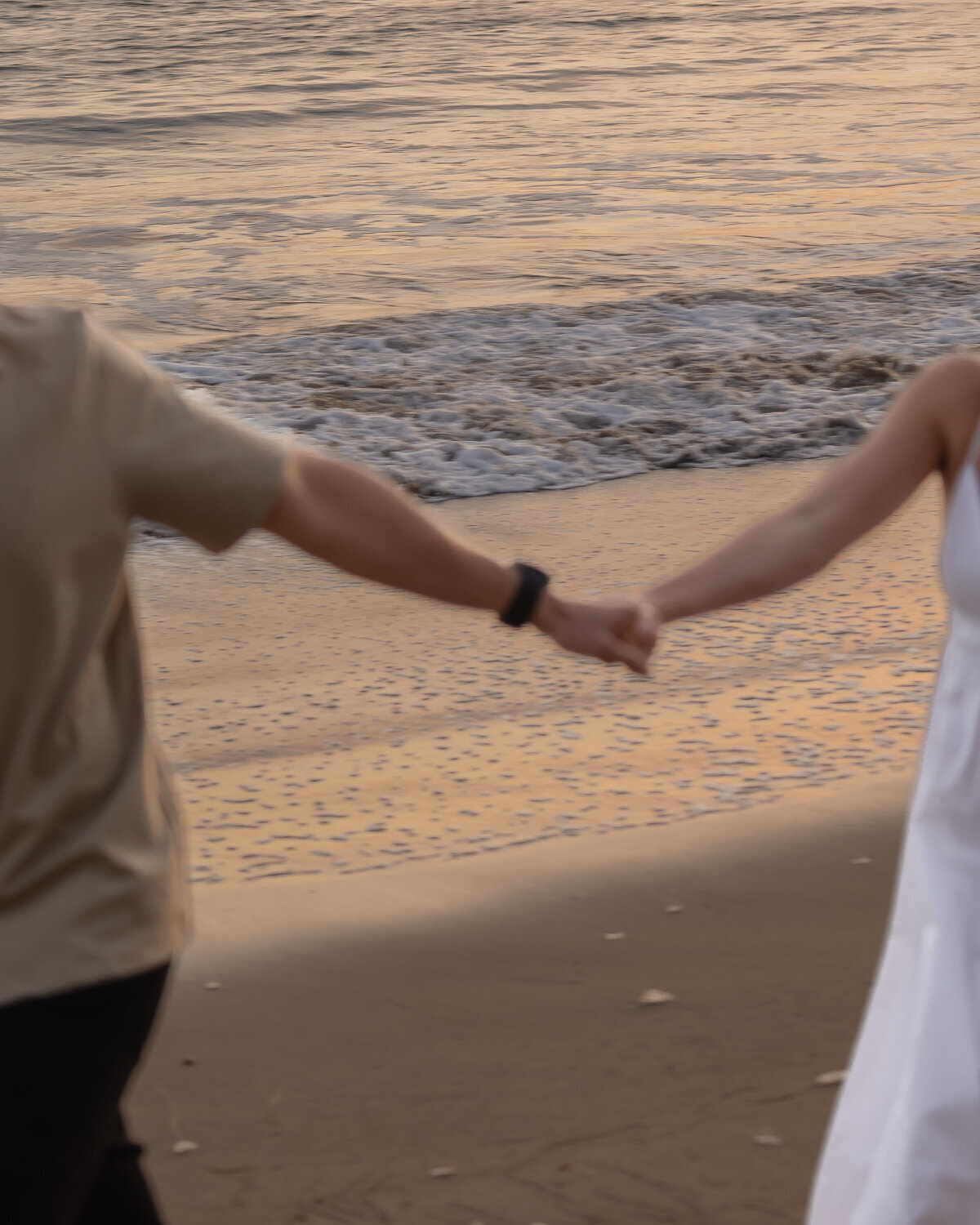 Couples Engagement Photos holding hands on beach in the Central Coast in Pismo Beach