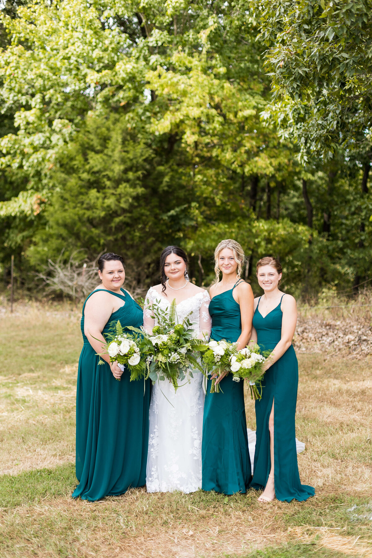 Bride with bridesmaids in green dresses at wedding at Mahr Park, Tennessee