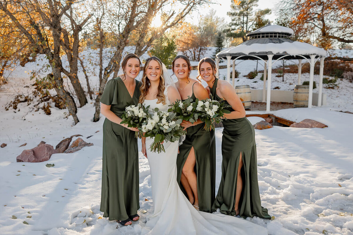 bride and bridesmaids smiling for a posed portrait at creekside terrace, expertly shot by Michelle Betz Photography