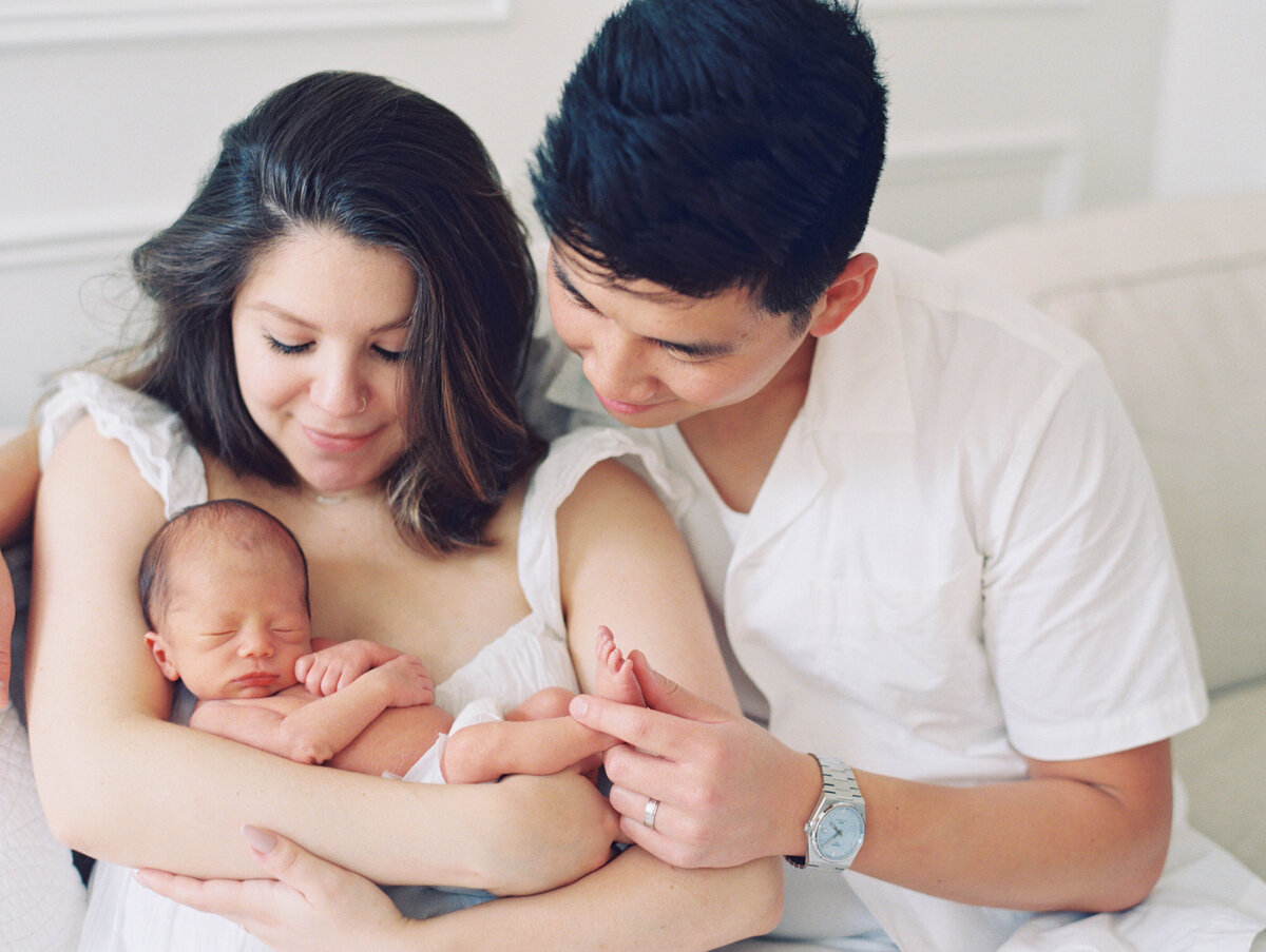 baby lying on bed by new hampshire newborn photographer