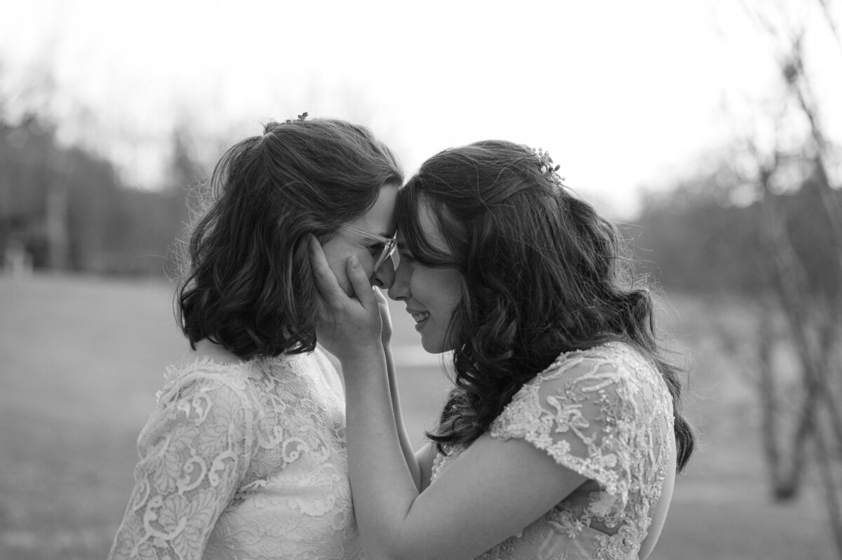 black and white image of two brides embracing