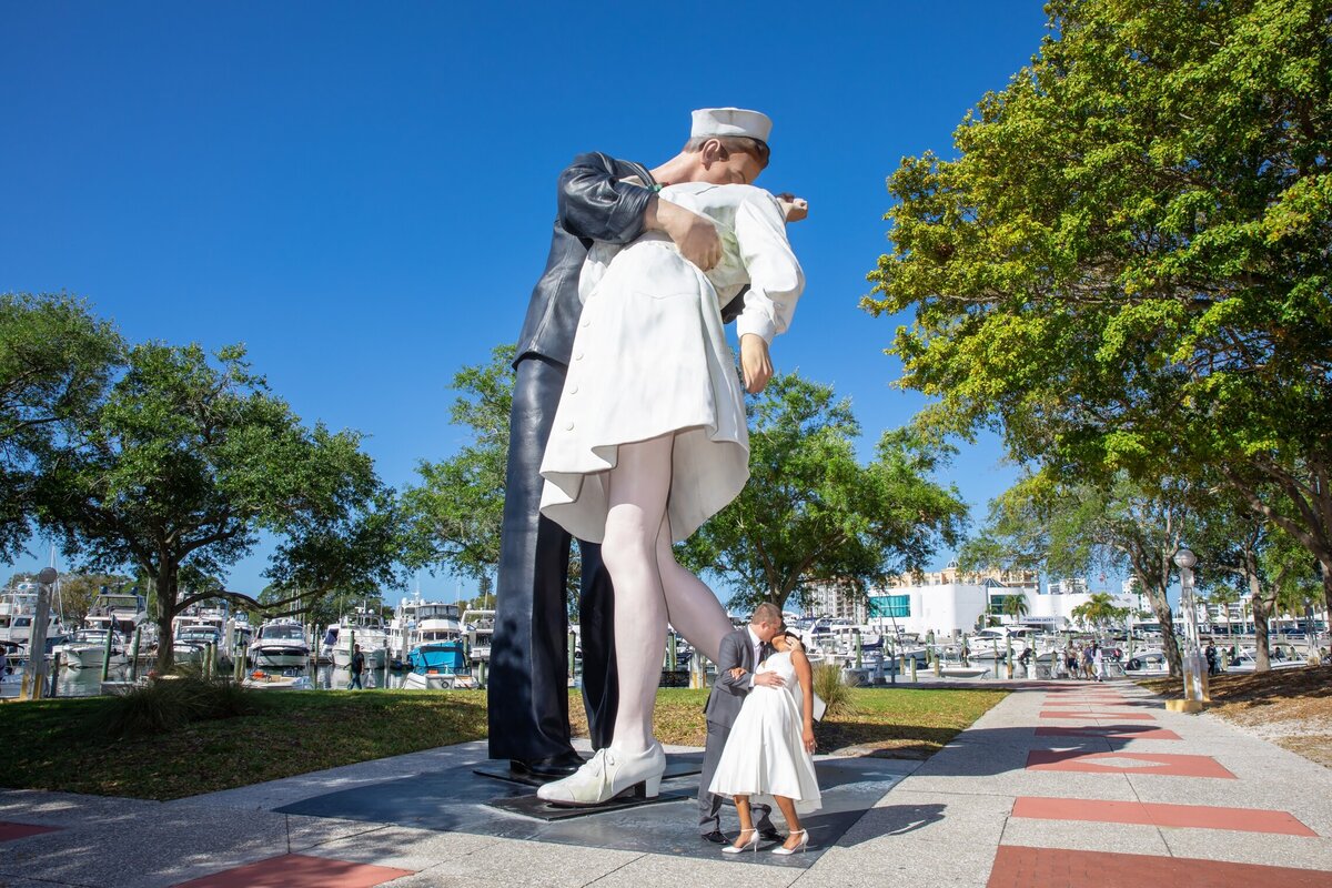 Couple kissing in front of the I surrender statue  downtown Sarasota