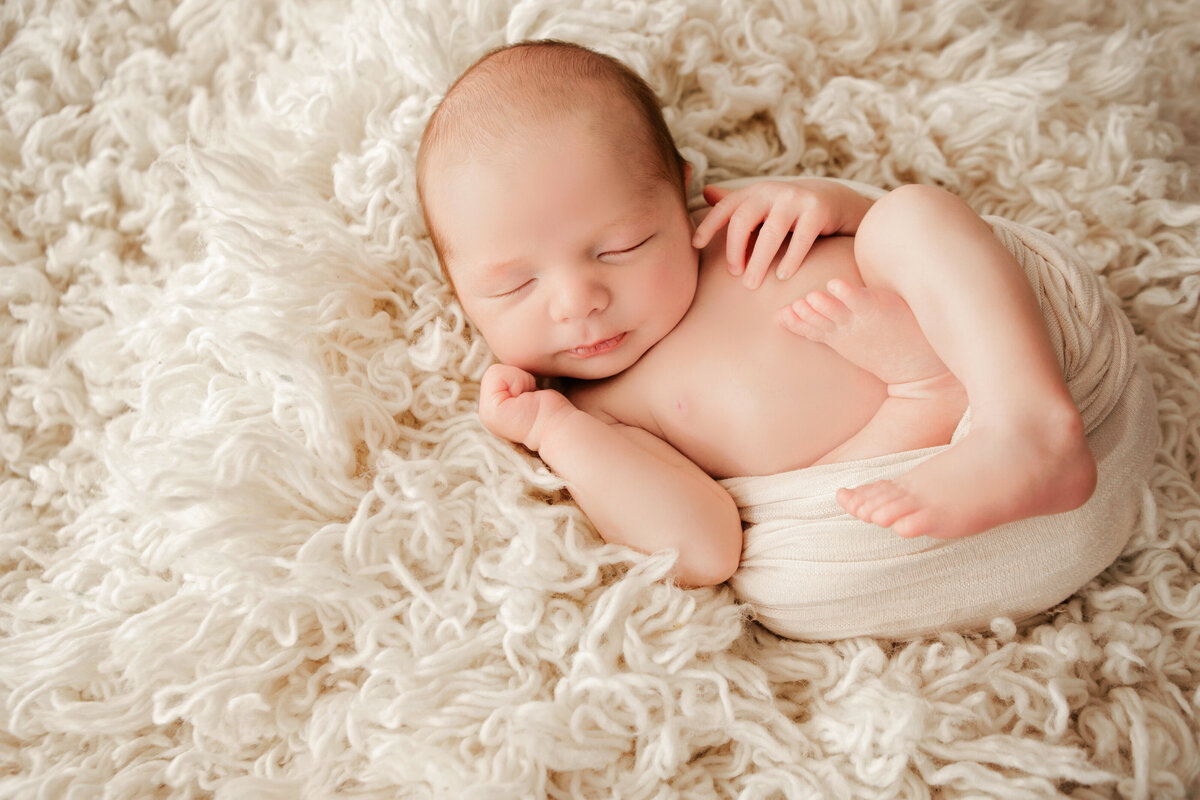 wrapped newborn in caccoon pose