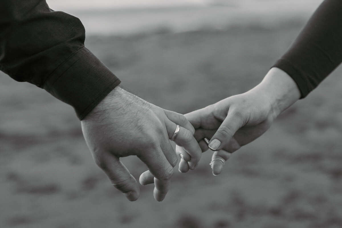 two people holding hands in a field