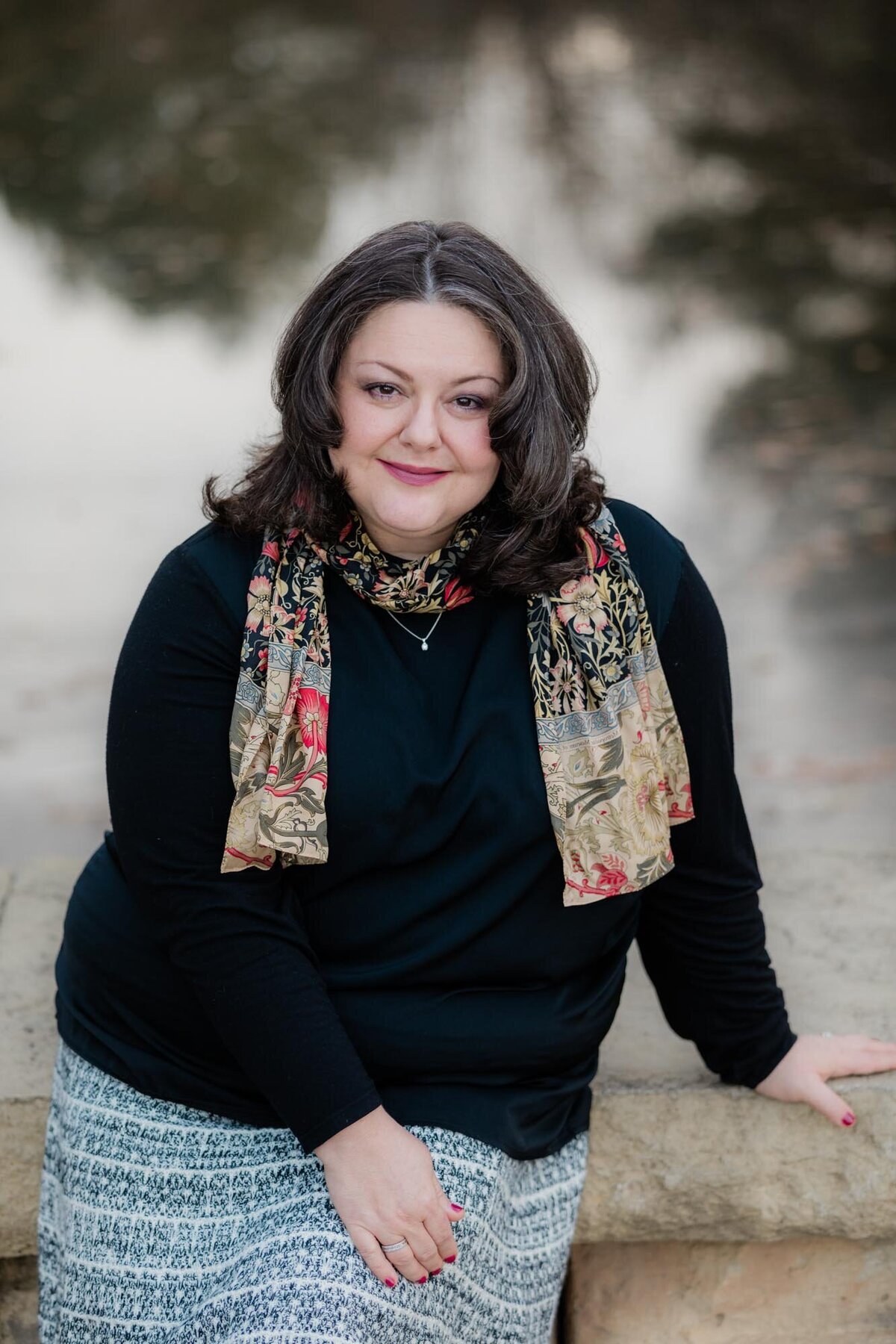 Branding headshot for a lovely woman in a black shirt and scarf.
