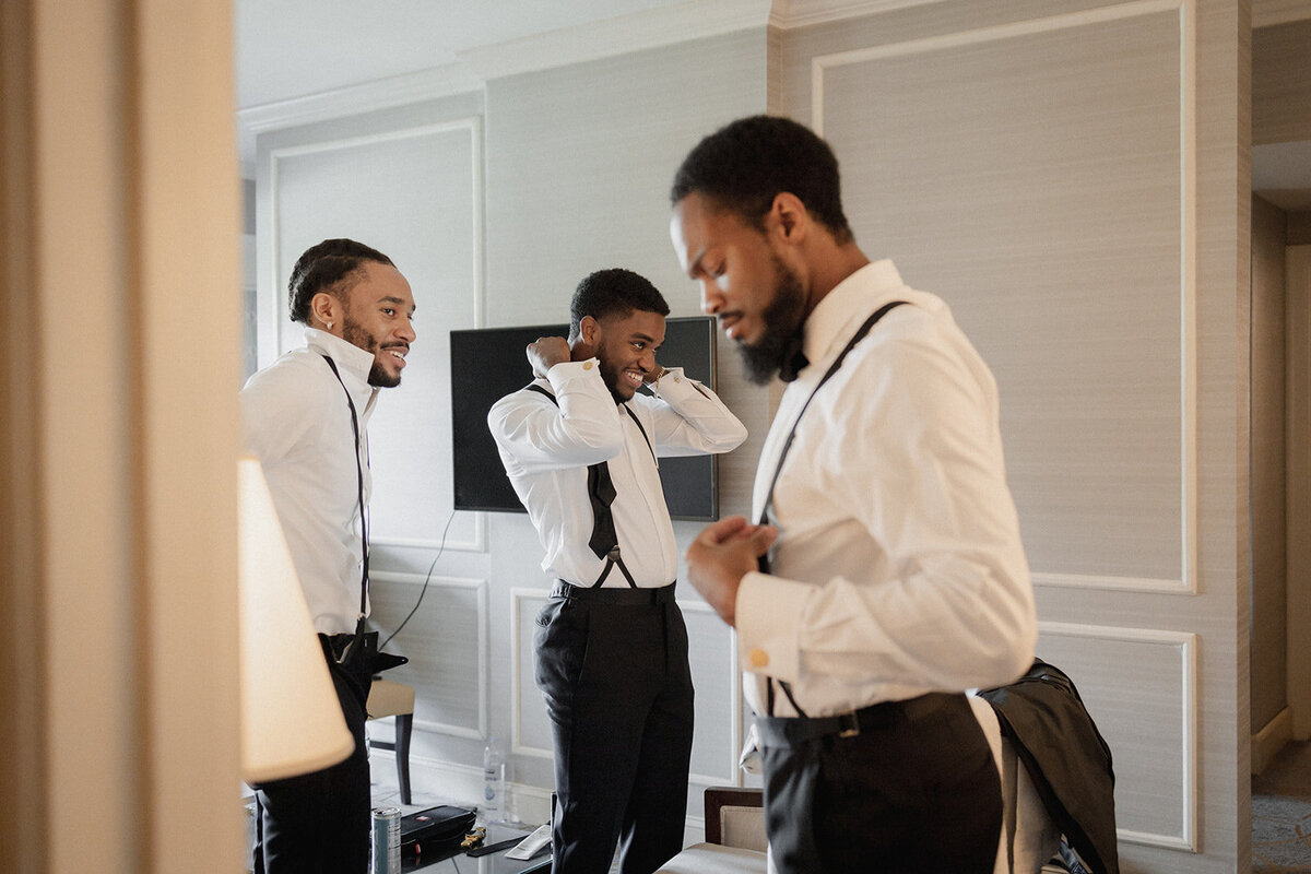 black groomsmen get ready for wedding ceremony