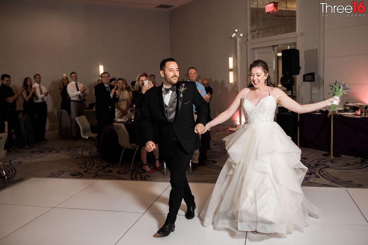 Bride and Groom walk out onto dance floor