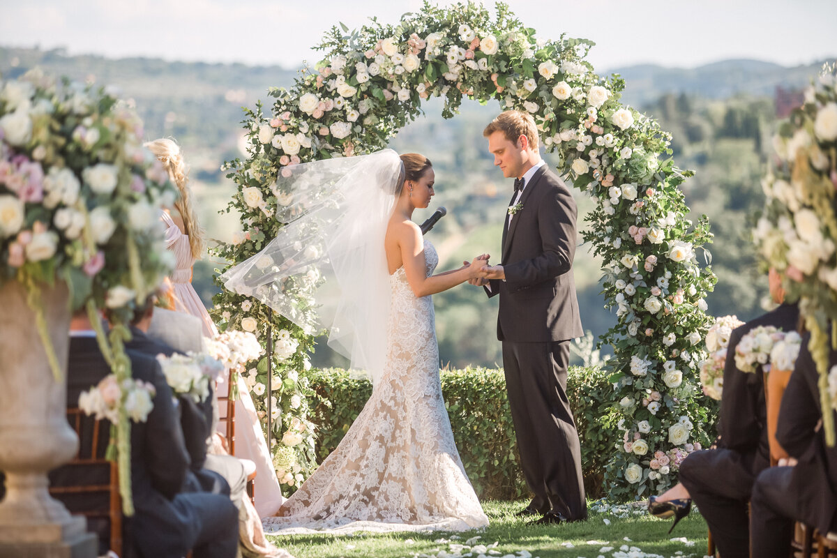 bride-groom-vows-under-floral-arch-in-florence-italy-upscale