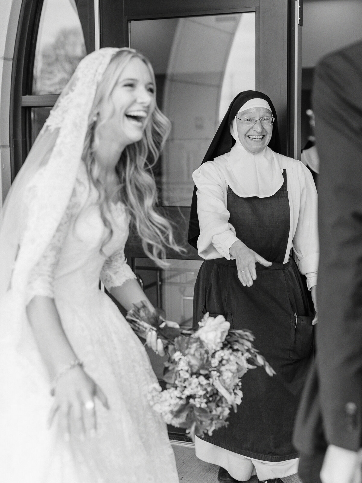 Bride and nun laughing after traditional Latin Mass wedding at Our Lady of the Assumption Church in Walton, KY