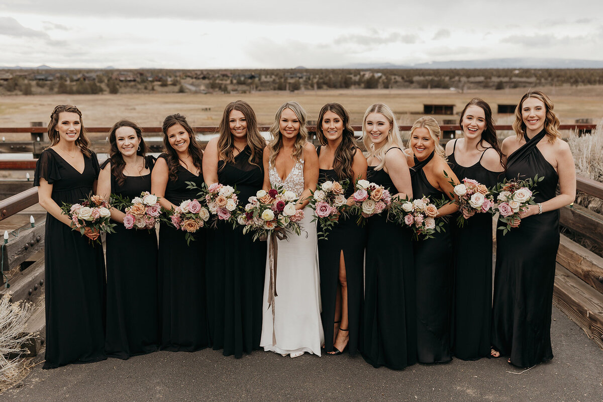 Bride with bridesmaids in black dresses at Brasada Ranch