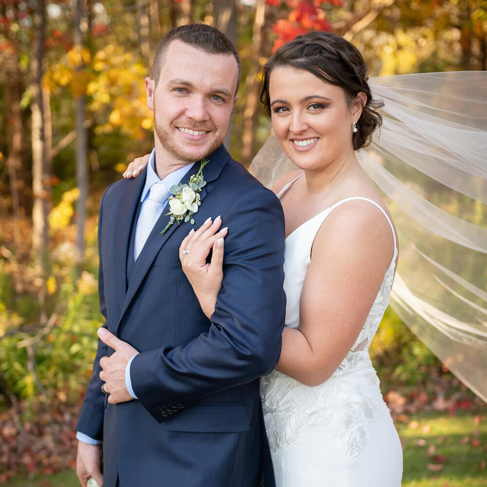 wedding couple together in a fall scene