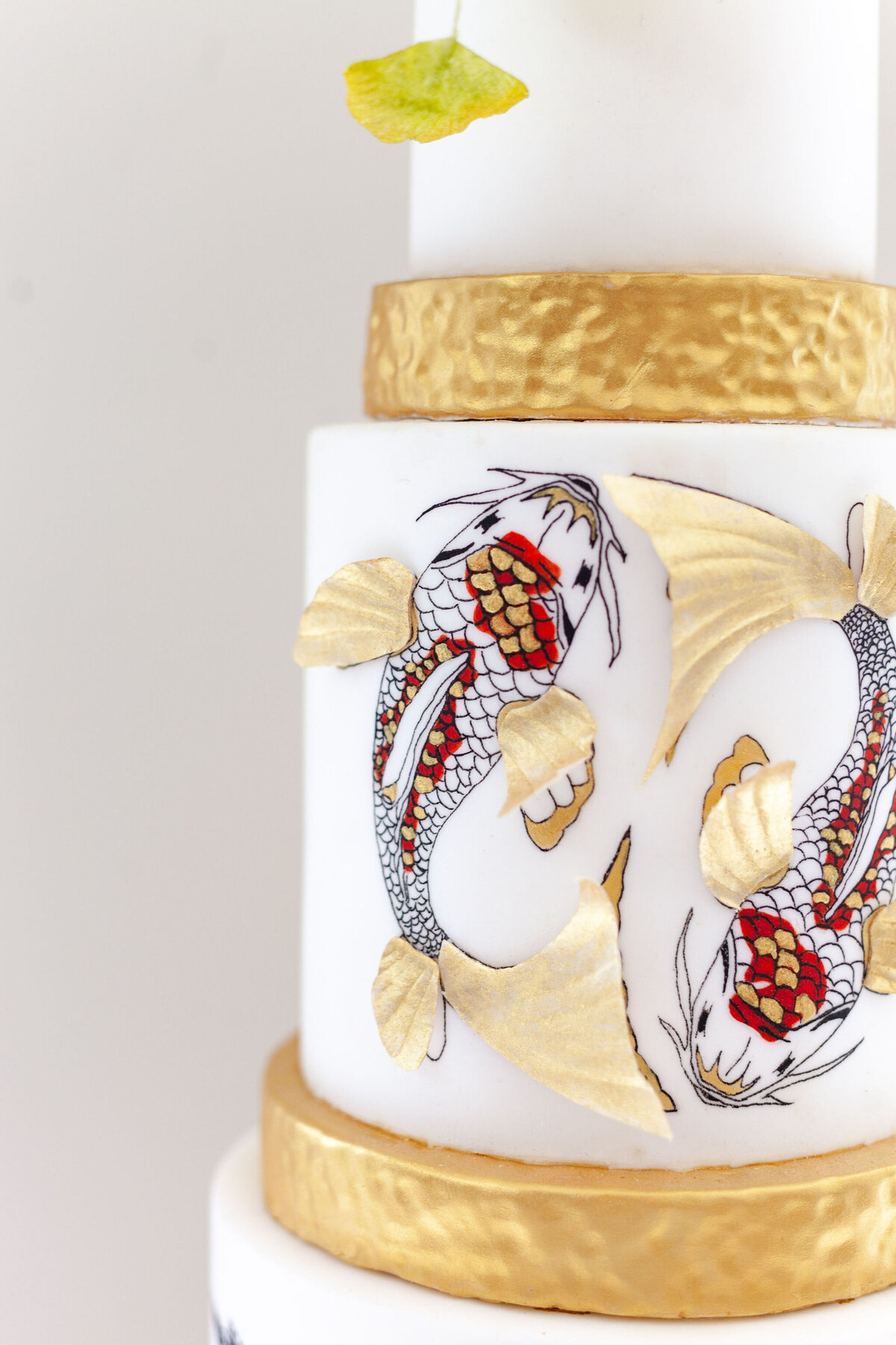 Luxury nature inspired wedding cake designer vanilla Spice Cake Studio Northamptonshire oriental hand painted koi carp gold leaf design