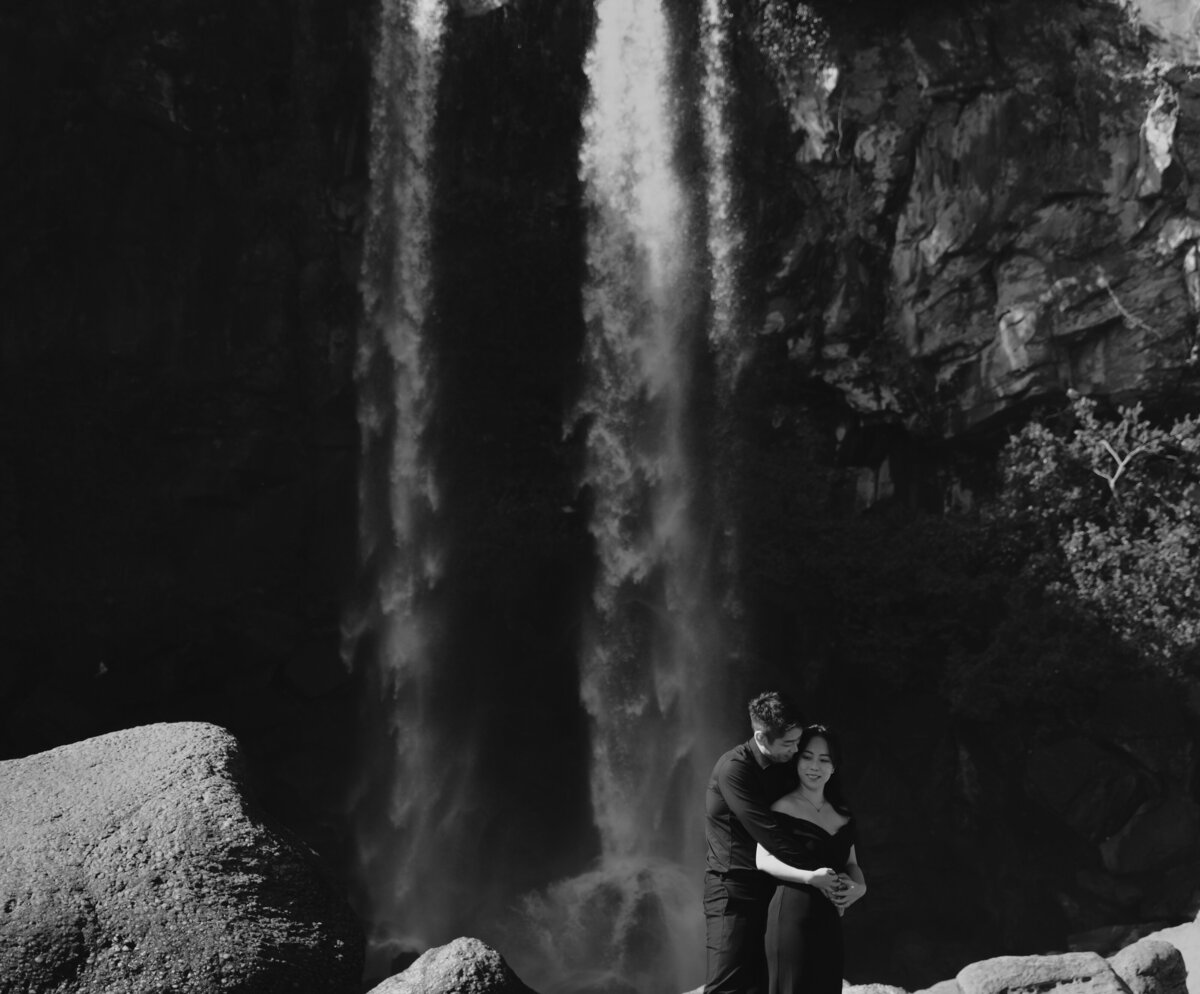 a man hugs a woman from behind on Jeju Island