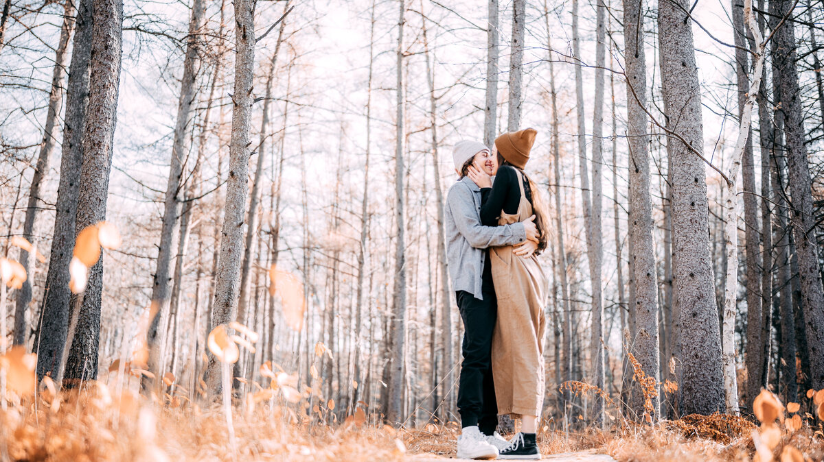 Explore the magic of Theodore Wirth Park as a young teenage couple embraces their love in the heart of the forest. This image captures their genuine affection surrounded by the serene beauty of nature, making it a testament to young love and the tranquility of the park.