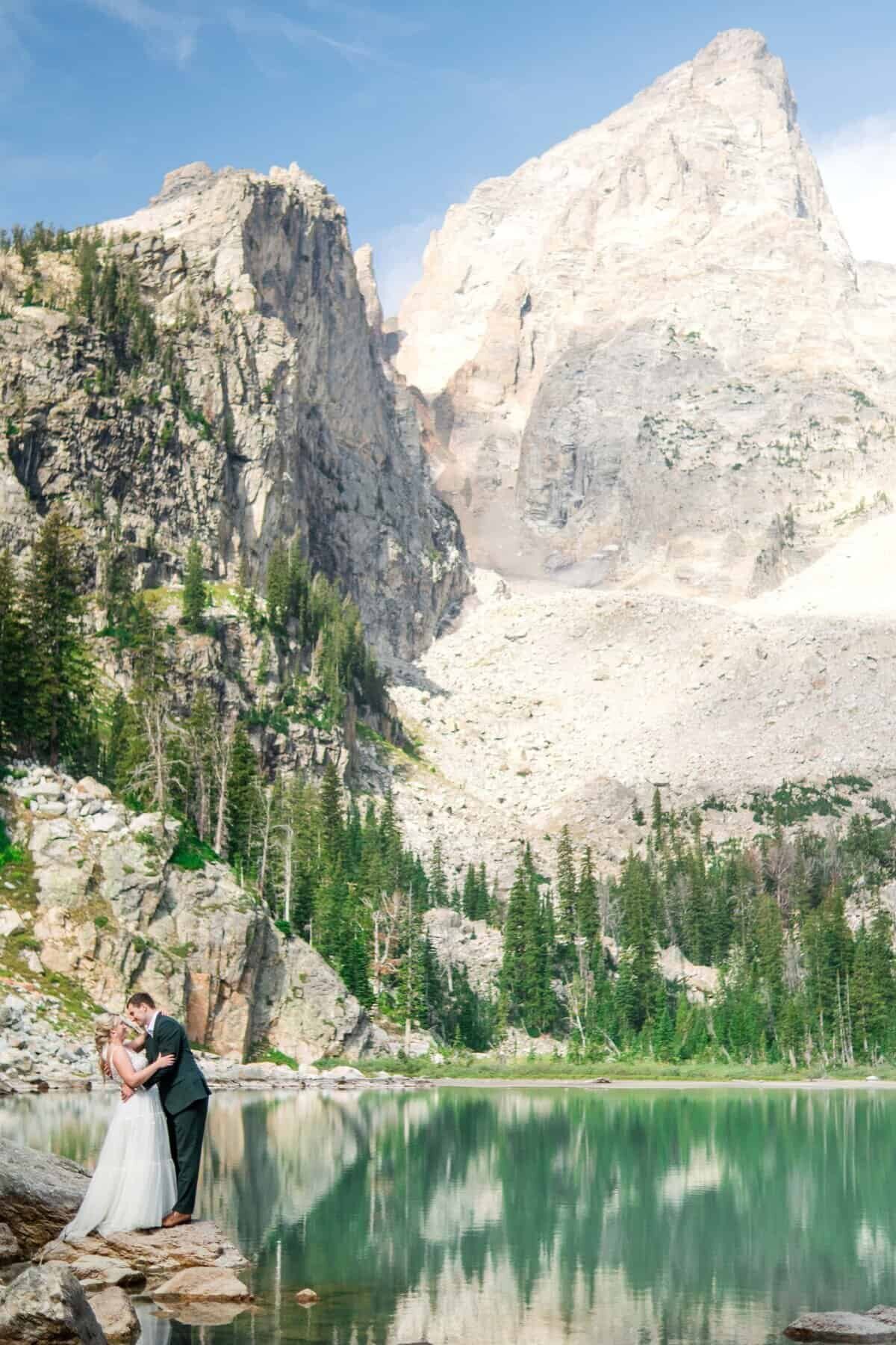 bride and groom share a kiss at the top of delta lake