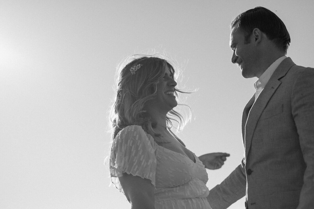 bride laughs as the looks into the eyes of her groom during their elopement ceremony at Hosmer Lake in Bend, OR