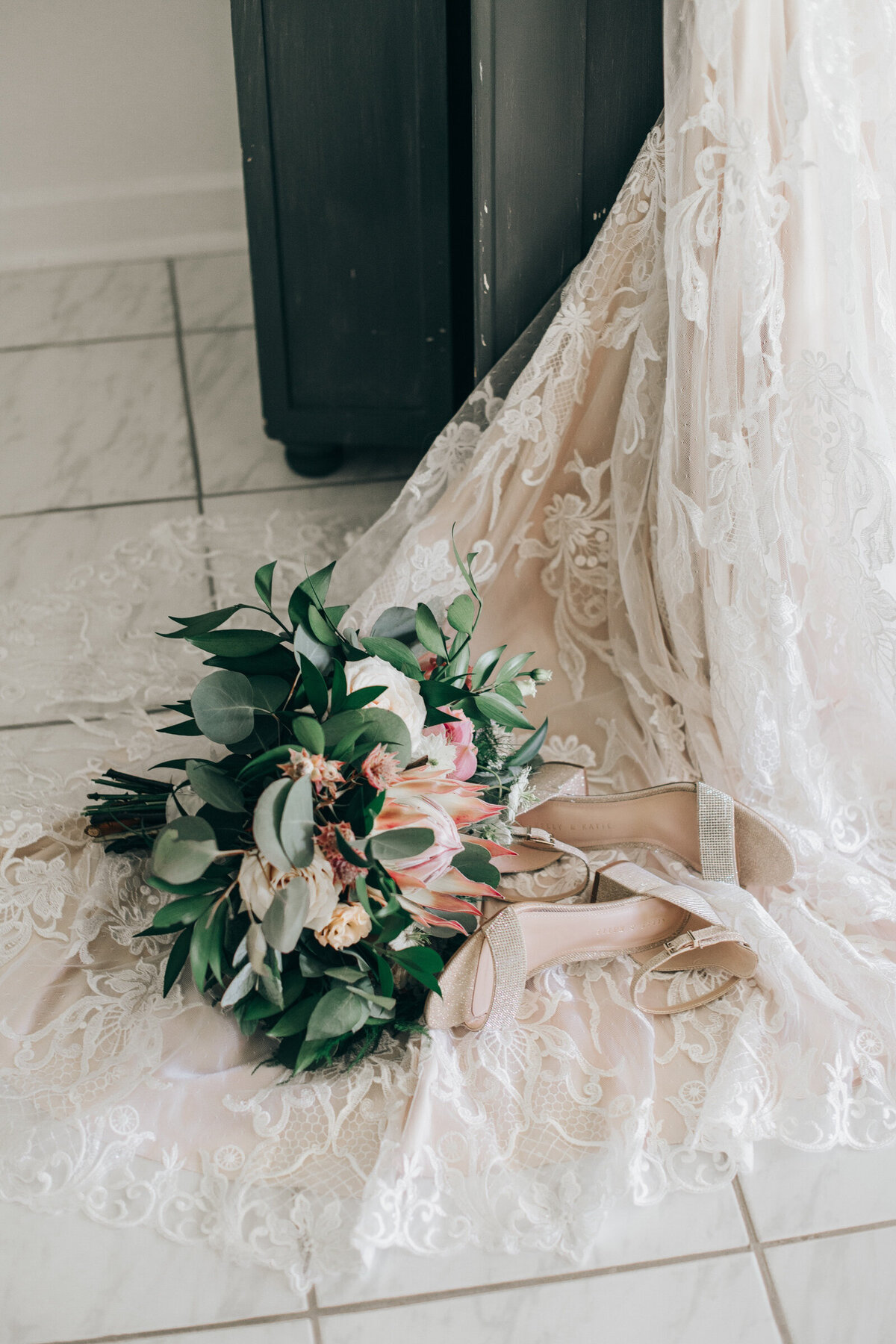 A bride's whimsical wedding bouquet and her diamond wedding shoes