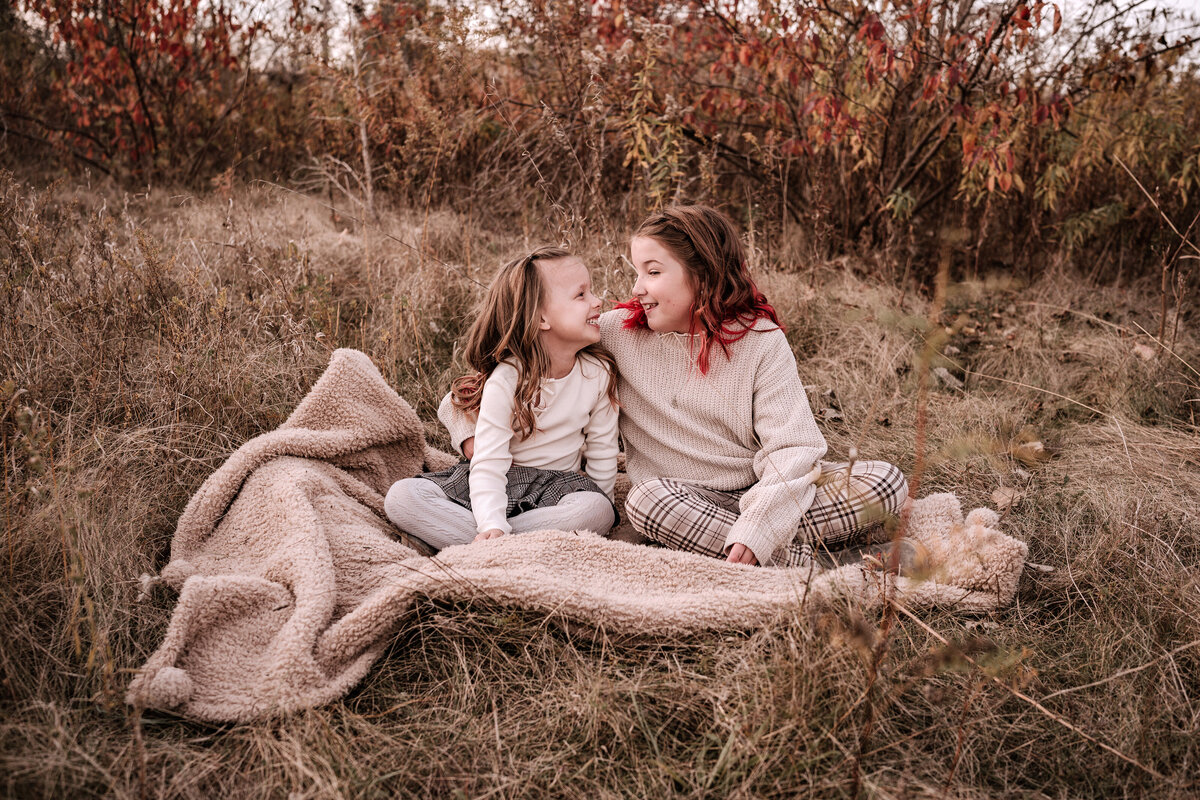 Sisters sitting on a blanket