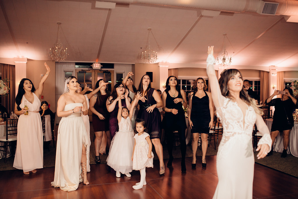 Wedding Photograph Of Women In White And Maroon Dresses Raising Their Hands Los Angeles