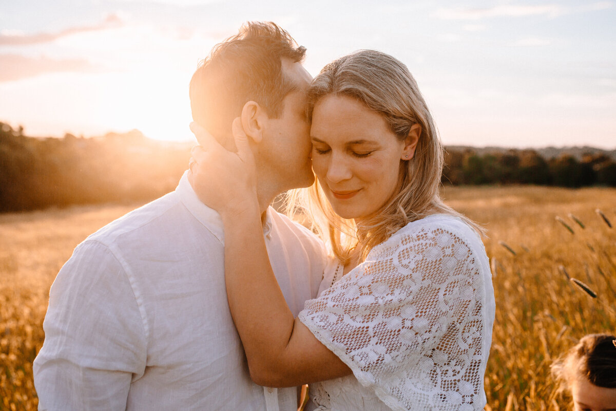 Couple intimate photograph in field at sunset with Sapphire and Stone Photography