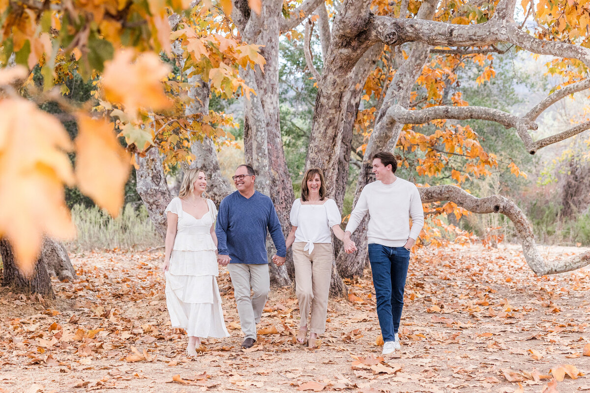 parents with adult children walking under tree san diego