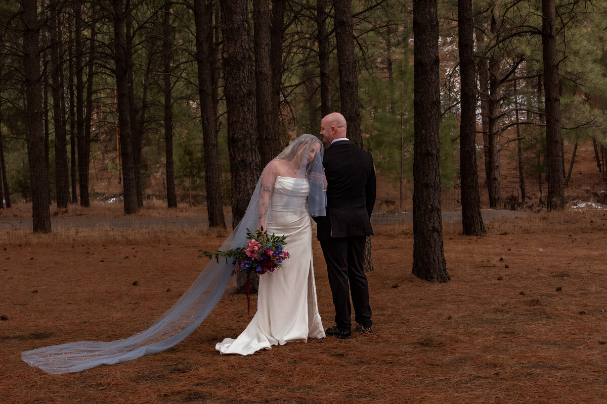 Couple exchanging vows during their outdoor forest wedding in Utah, photographed by Lamblight Photography
