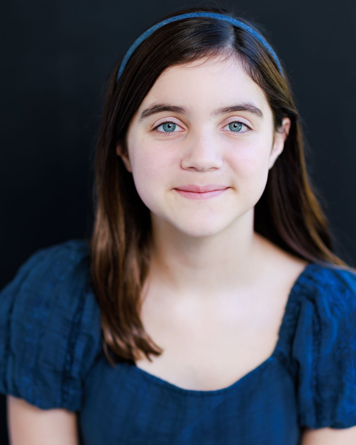 Beautiful girl with blue eye and blue dress black background.