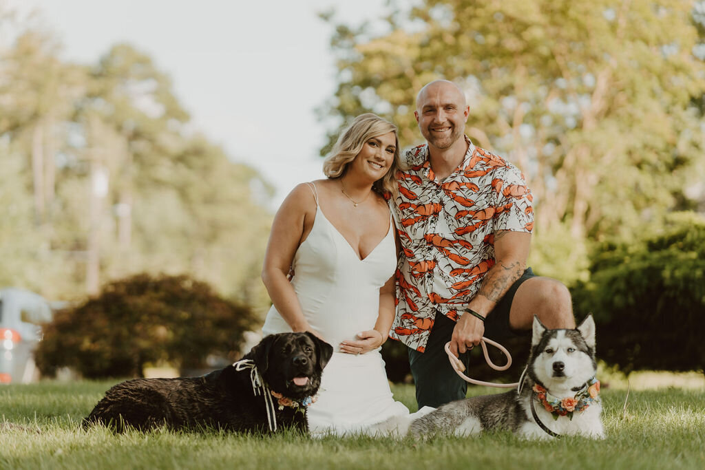 Bride with her husband and two dogs at their wedding