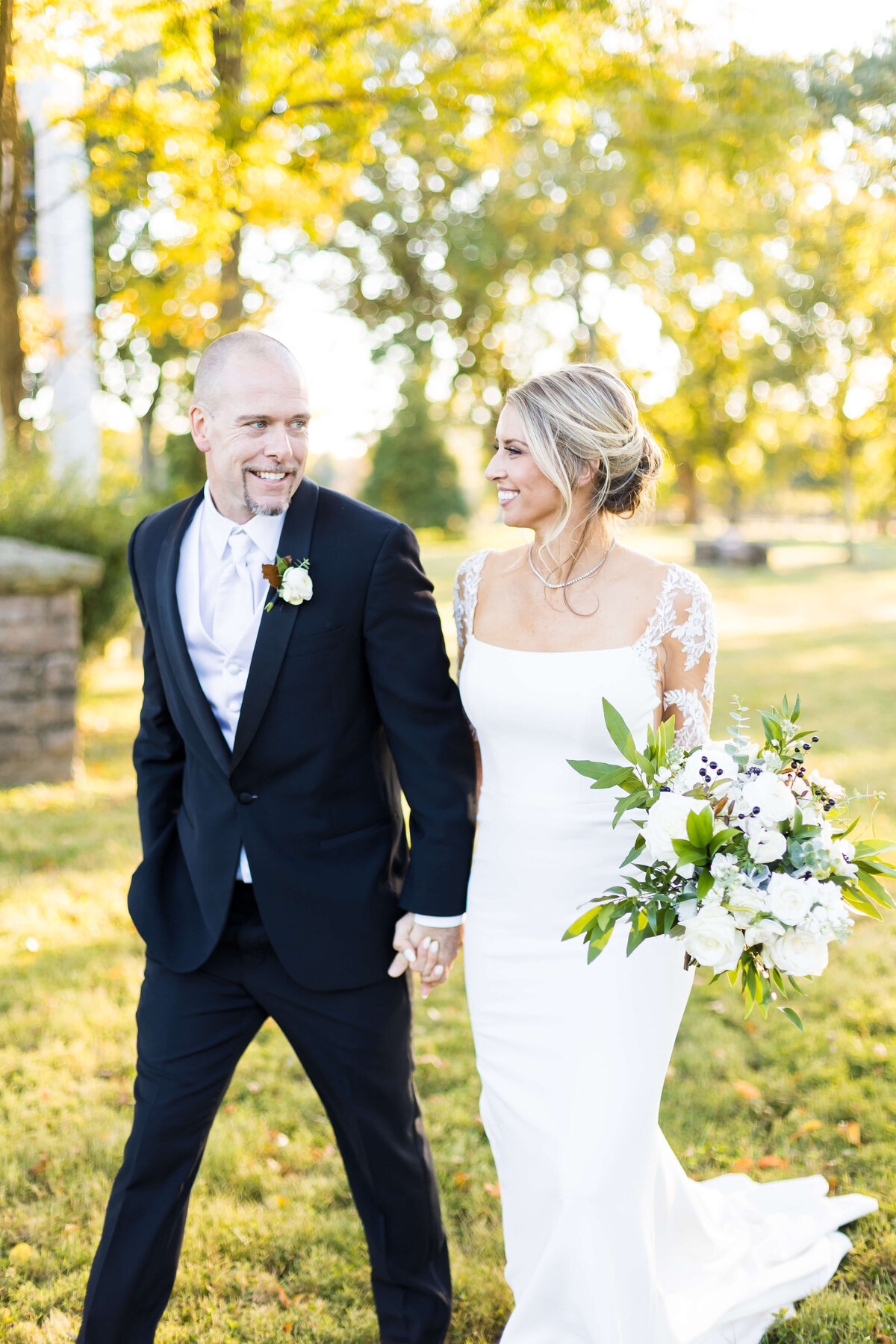 Bride and groom walking along grassy area in Nashville