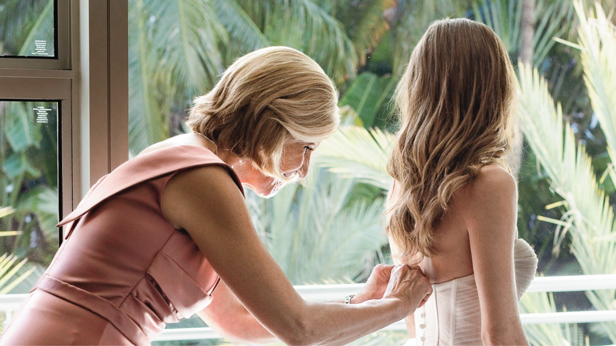 Mother helping bride with her dress at The National Hotel, captured by Claudia Amalia Photography, a Miami and Florida Keys wedding and lifestyle photographer specializing in destination weddings