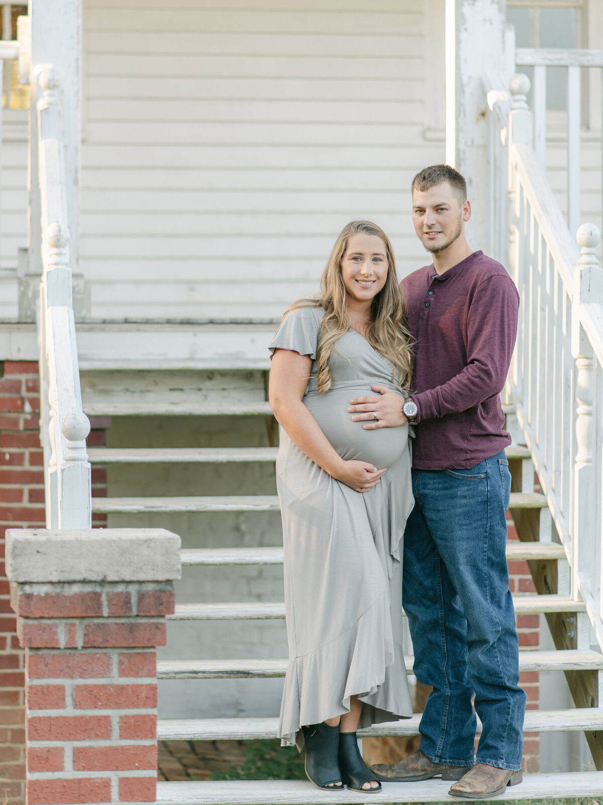 Mom and Dad standing on old porch steps.