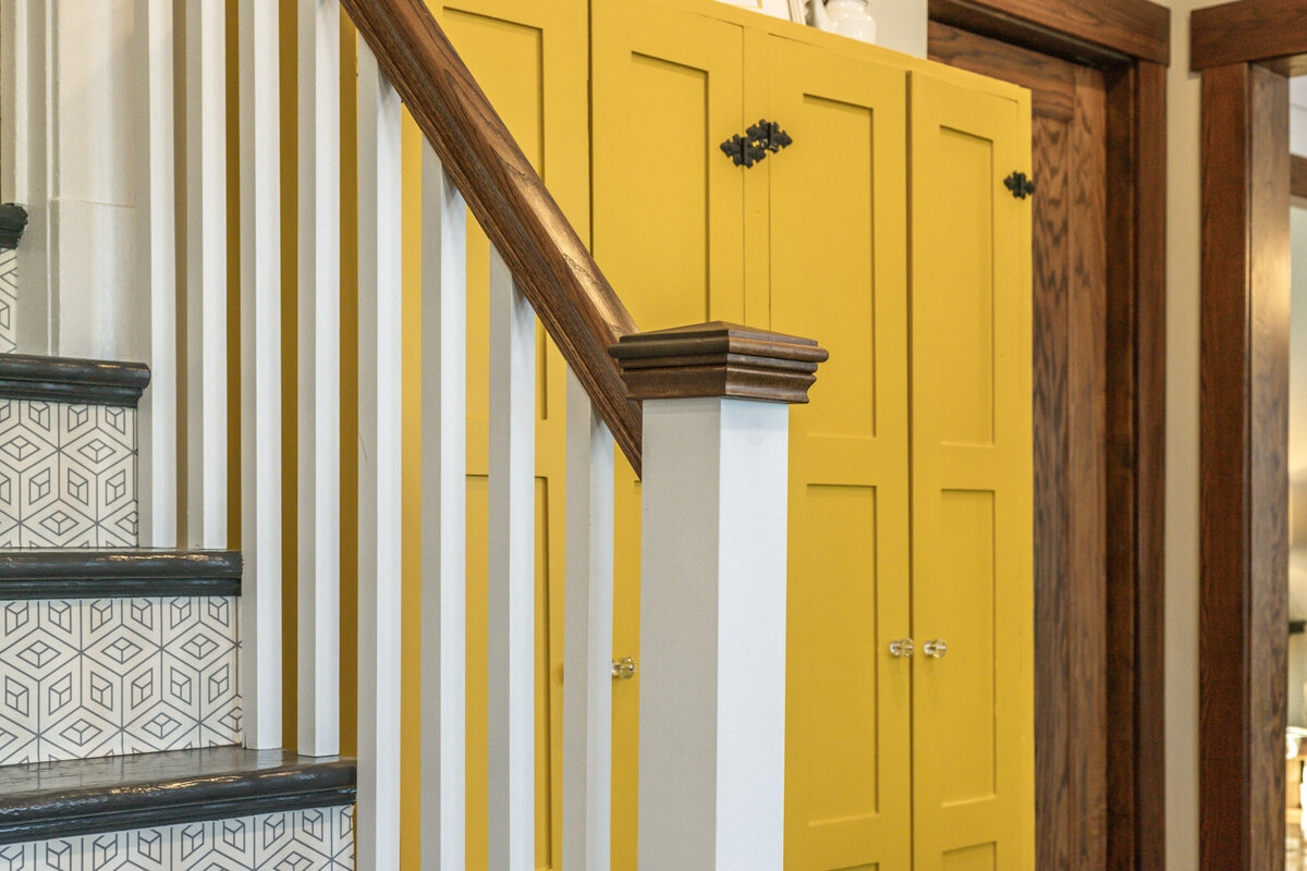 staircase and yellow cabinets