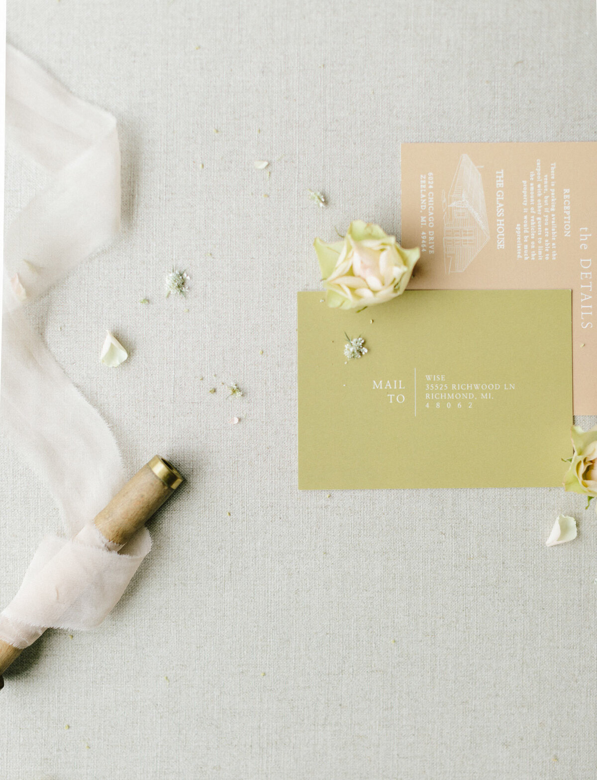 wedding stationery with flowers and ribbon at Glass House Community, unique Michigan wedding venue