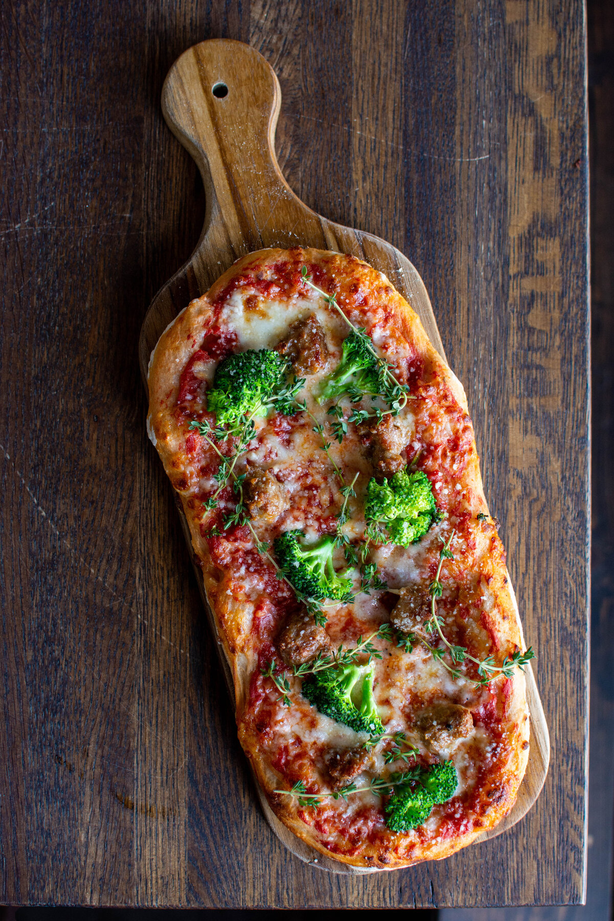 Pizza with mozzarella, tomato sauce and broccoli and sausage