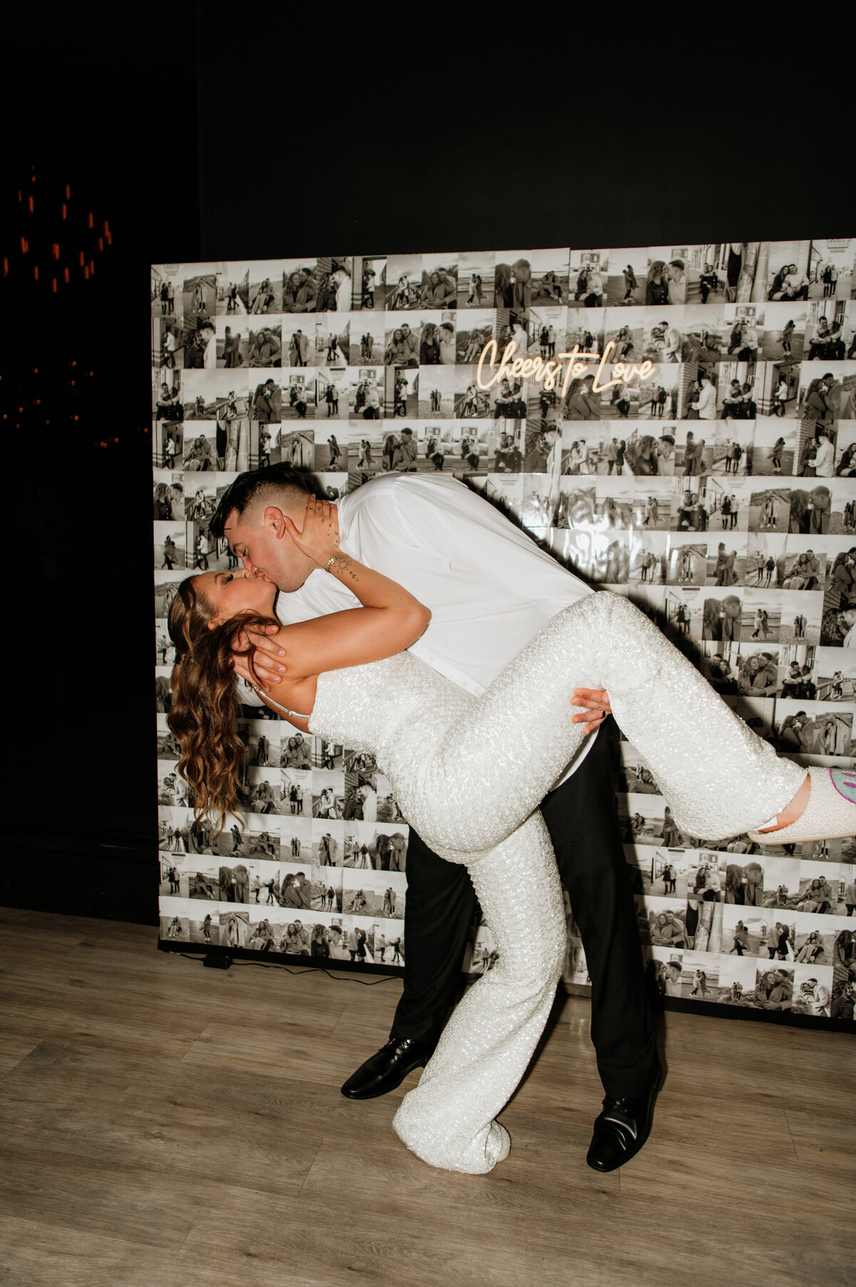 Groom dipping bride for kiss at reception